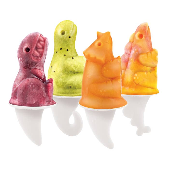 Four dinosaur-shaped popsicle molds in red, green, orange, and yellow, each with a white tail-like handle
