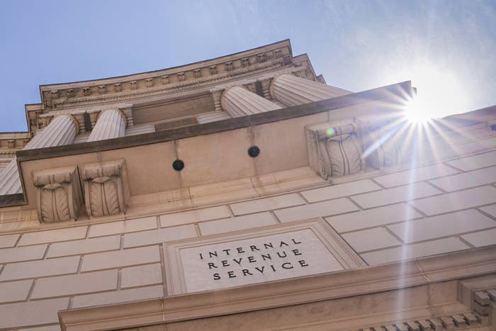 Exterior view of IRS building with sun shining, showcasing columns and stone architecture