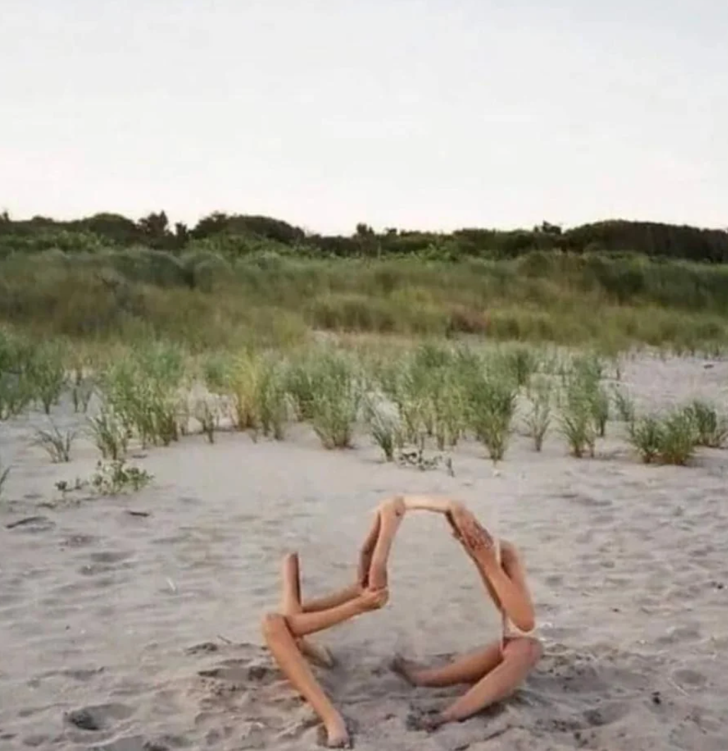 Two radical   successful  swimsuits connected  a sandy formation  make  an illusion by intertwining their limbs successful  a playful arch shape