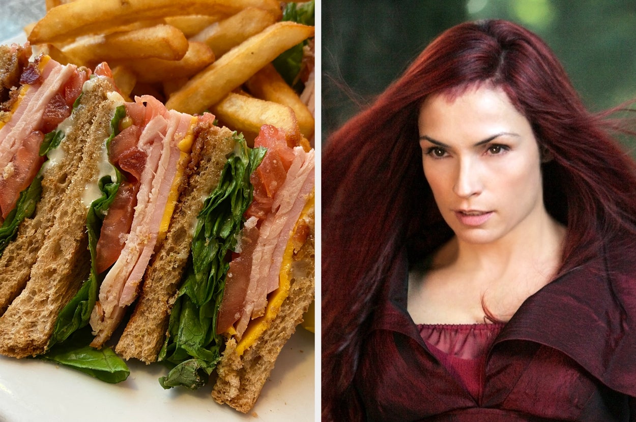 A club sandwich with fries next to a person with red hair wearing a dark red, elegant outfit