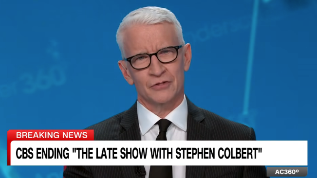 News anchor reporting CBS ending &quot;The Late Show with Stephen Colbert&quot; on a broadcast with a blue studio background