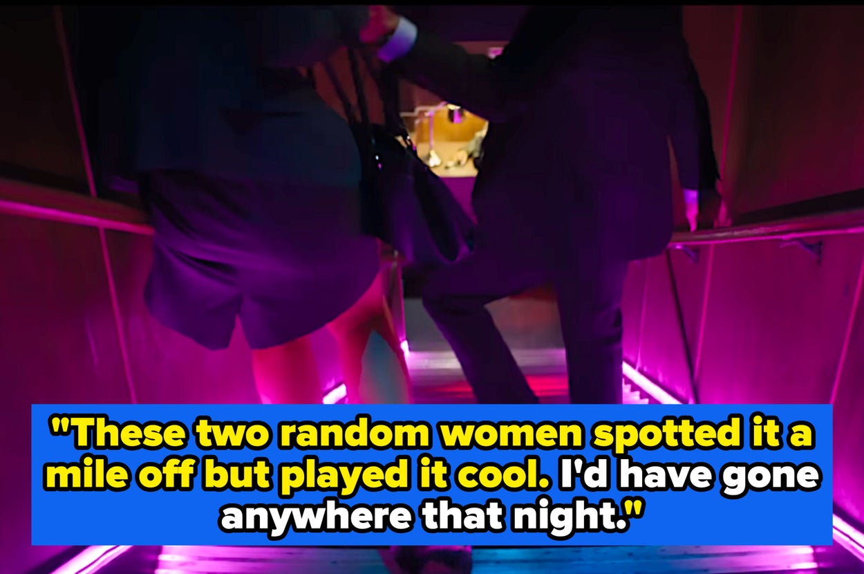 Two people in business attire walk down stairs with neon lights, suggesting a vibrant nightlife setting or modern event entrance