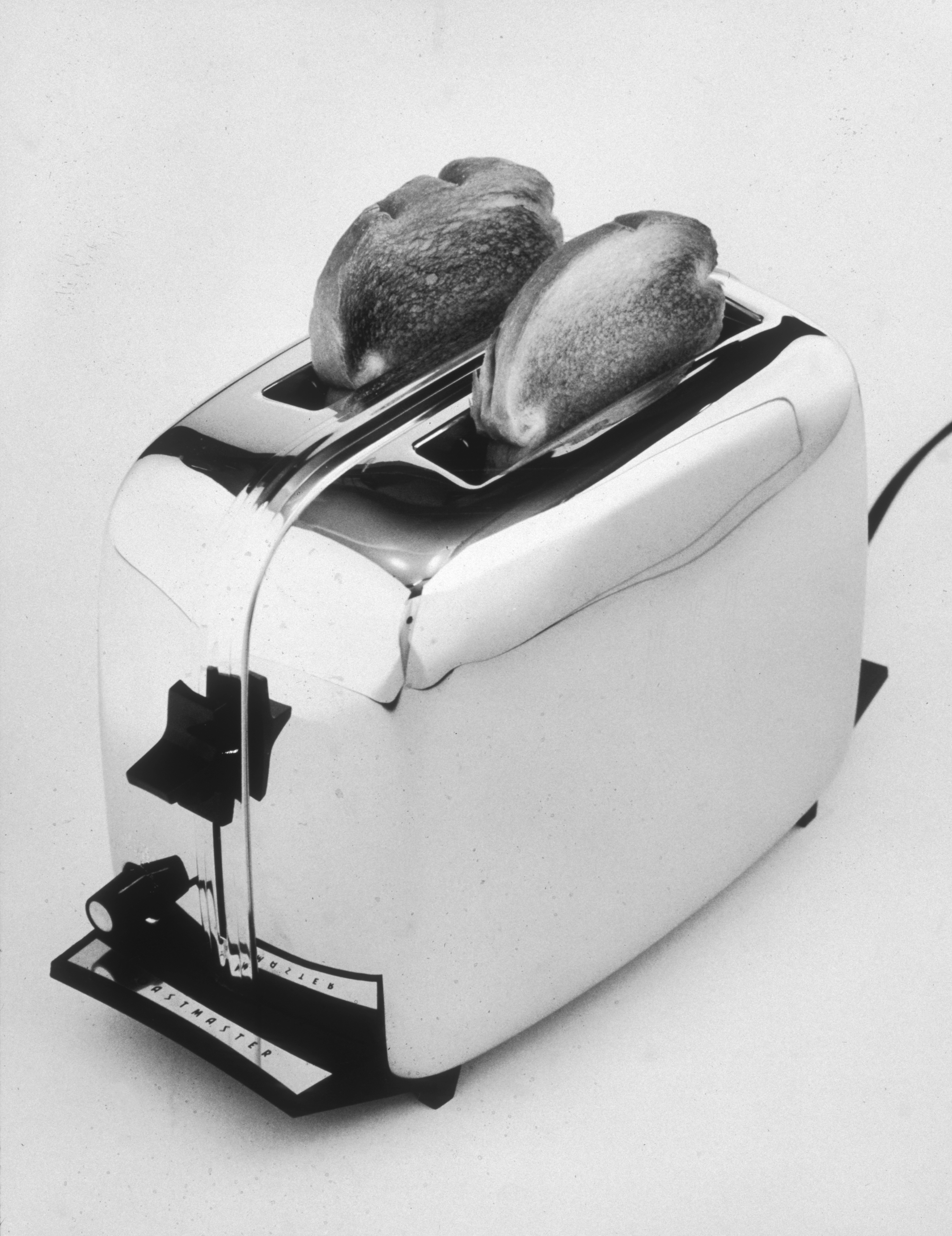 A chrome toaster with two slices of bread popping up. Retro design with lever and settings on the front