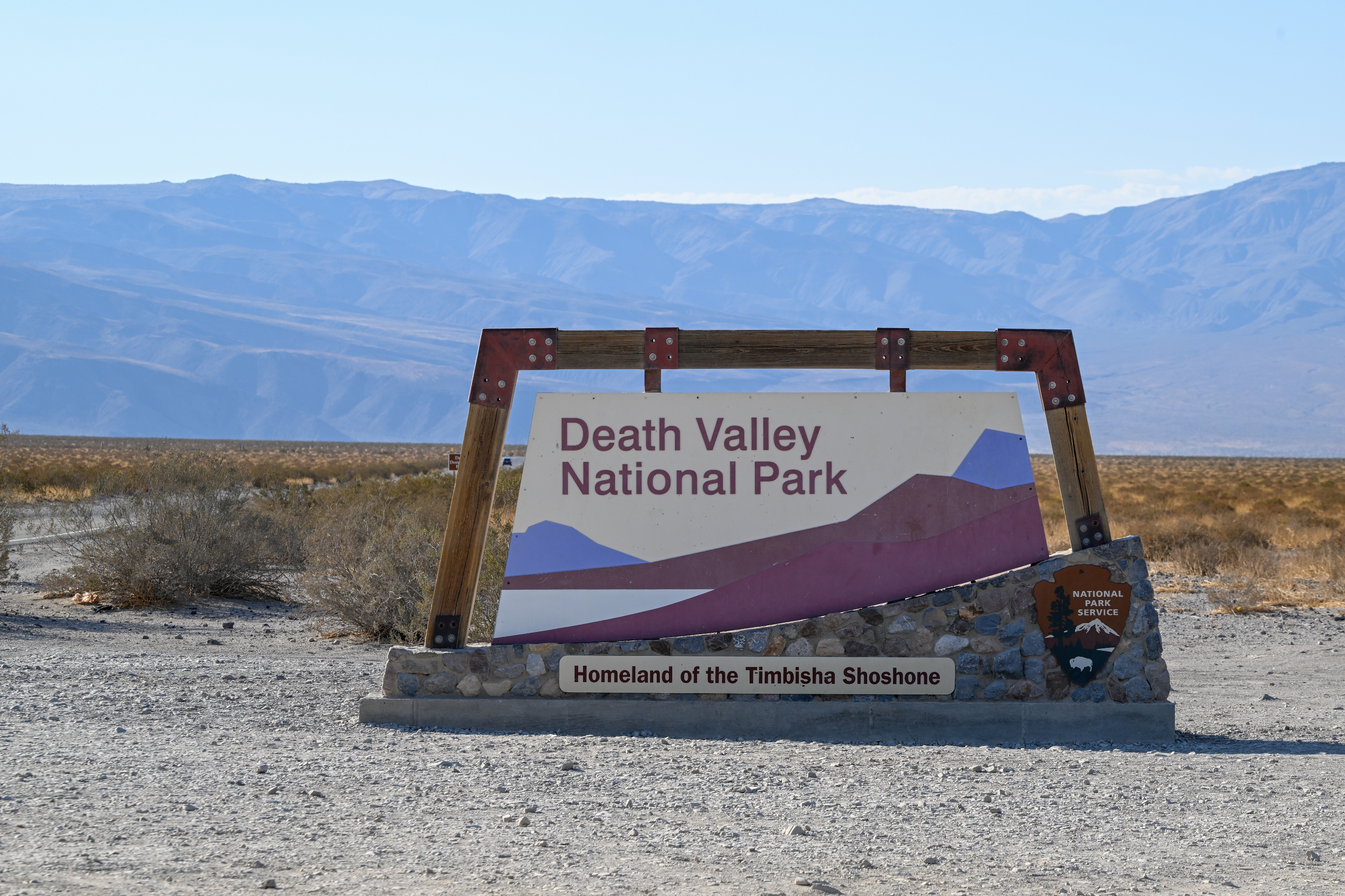 Sign for Death Valley National Park in a desert landscape, marking the homeland of the Timbisha Shoshone