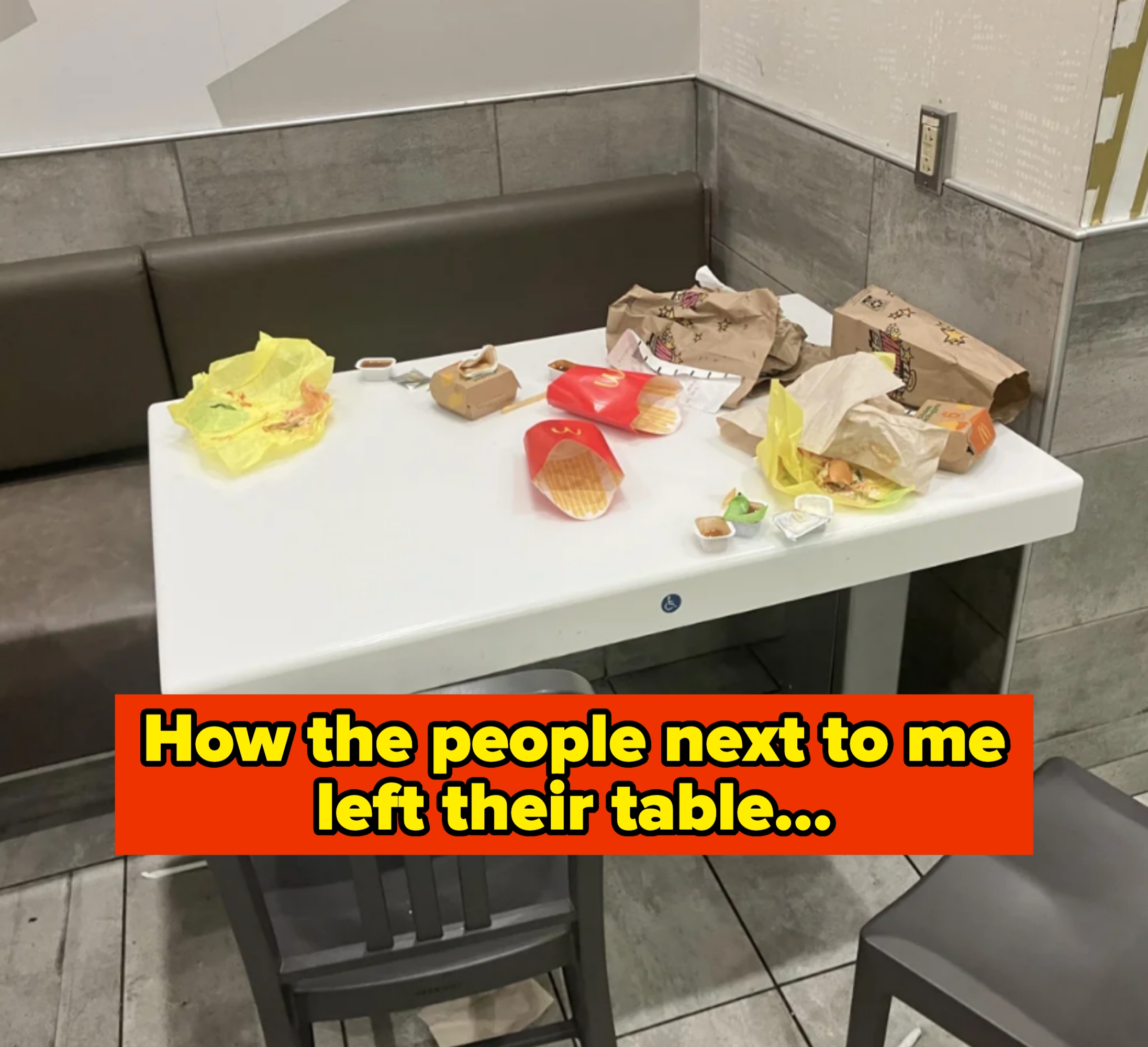 Restaurant table with empty fast food wrappers, fry boxes, and sauce containers left behind. Caption: &quot;how the people next to me left their table&quot;