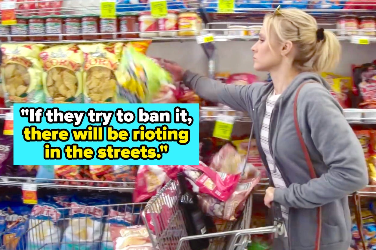 Kristen Bell in a casual zip-up hoodie and striped top reaching for chips in a grocery aisle. A quote overlay reads, "If they try to ban it, there will be rioting in the streets."
