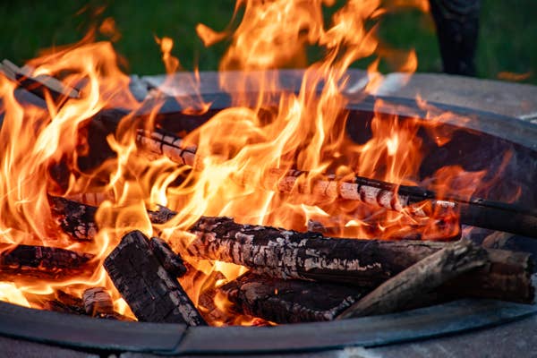 Logs burning in a fire pit.