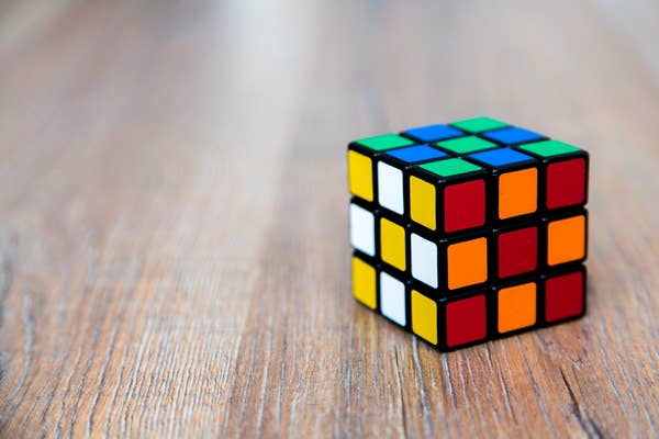 A Rubik's Cube on a wooden surface.