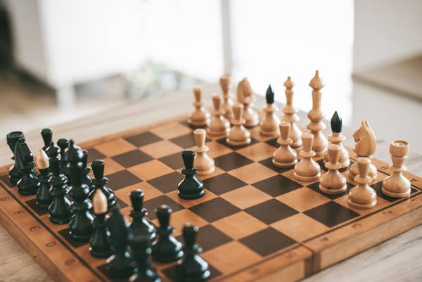 Chess set with various pieces on the board.