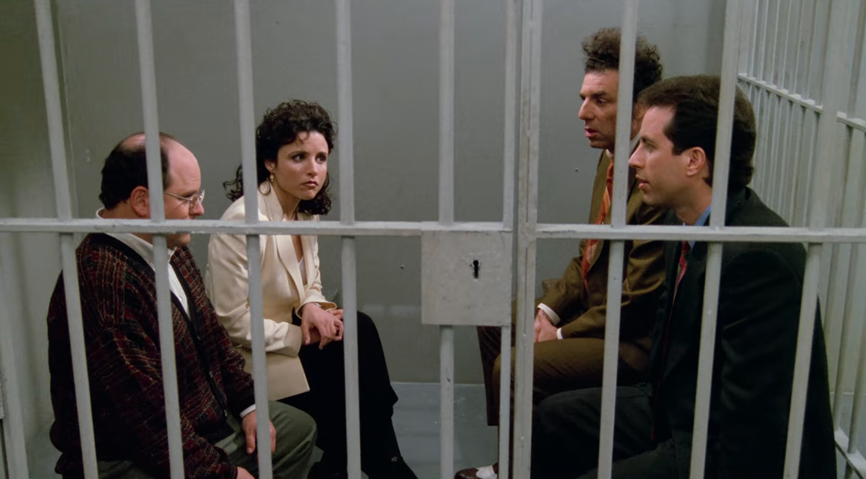 George, Elaine, Jerry, and Kramer sit in a jail cell together