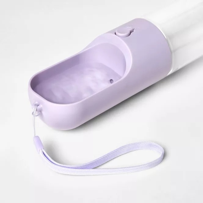Portable pet water bottle with a wrist strap and a button-operated dispenser. Ideal for on-the-go hydration for pets