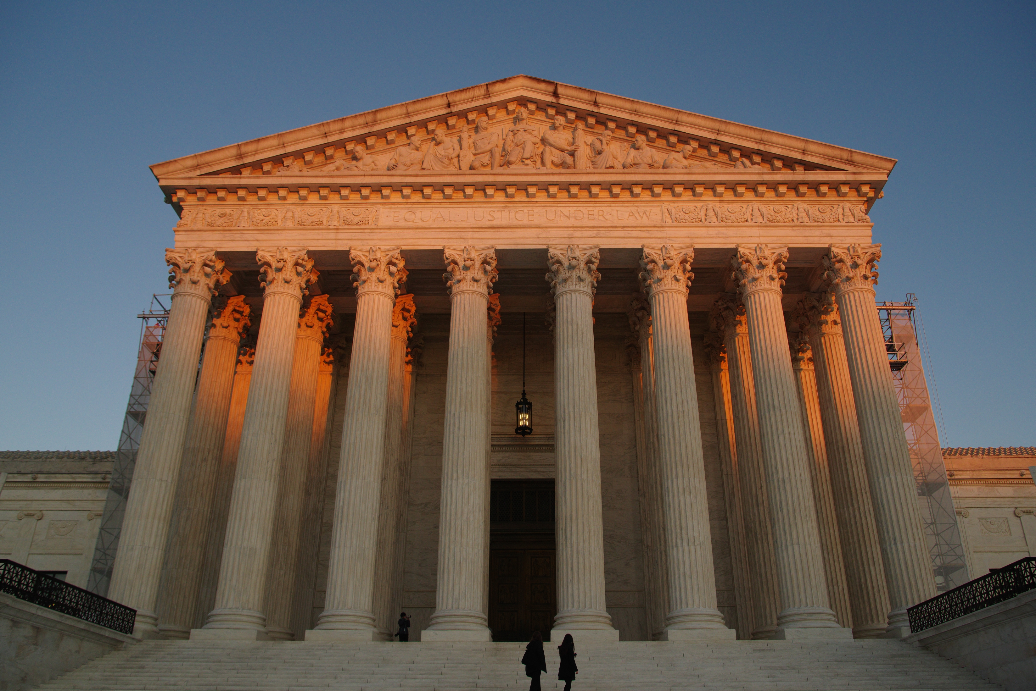 The U.S. Supreme Court building with its iconic columns, captured at sunset