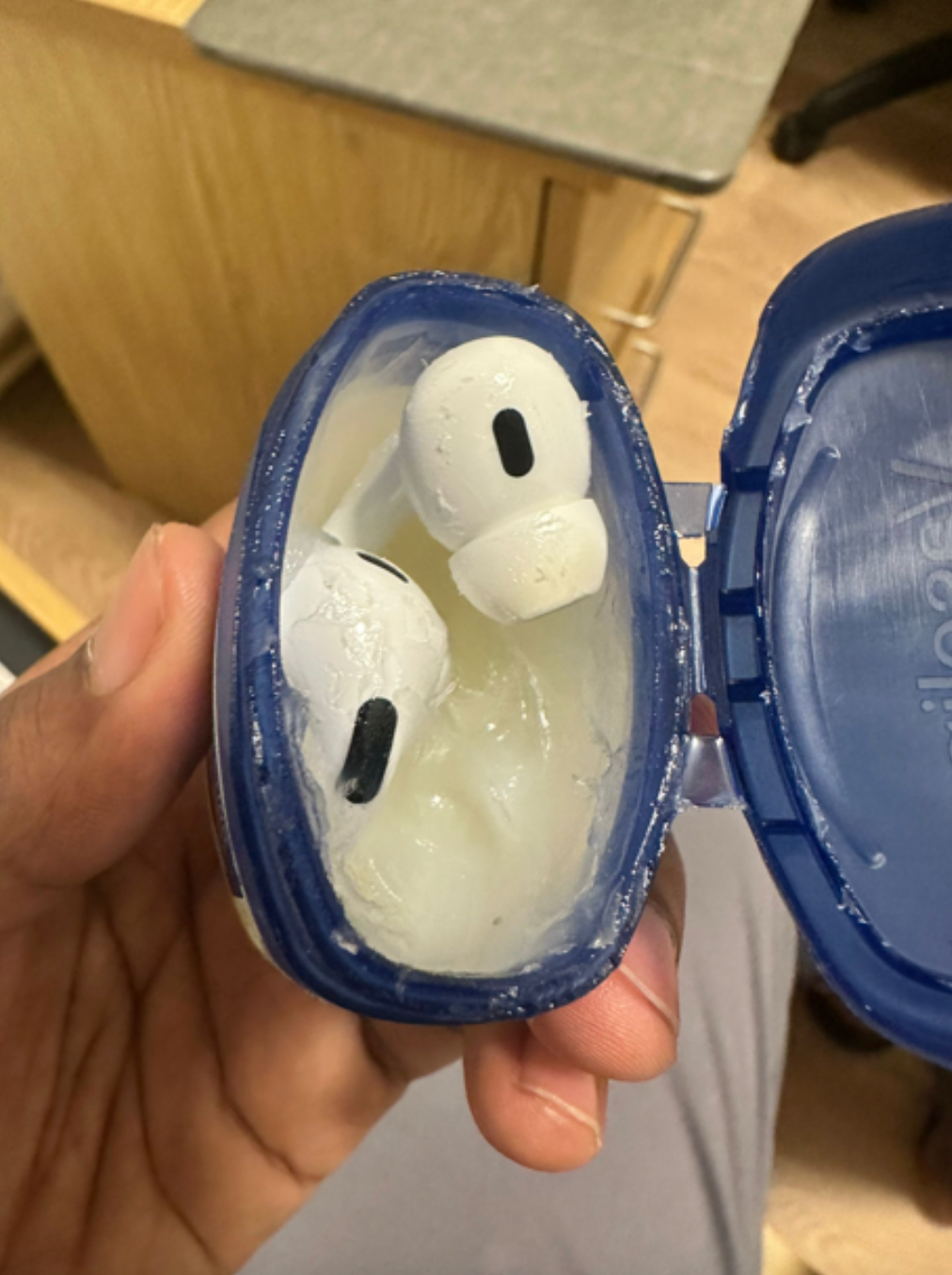 AirPods lawsuit  filled with a substance   resembling petroleum jelly, with 2  AirPods inside