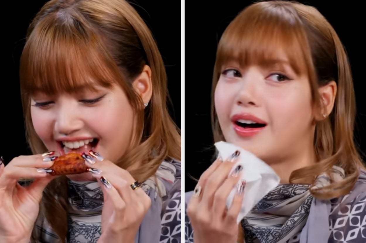 A person eats a spicy chicken wing and wipes their mouth, showing enjoyment and slight surprise