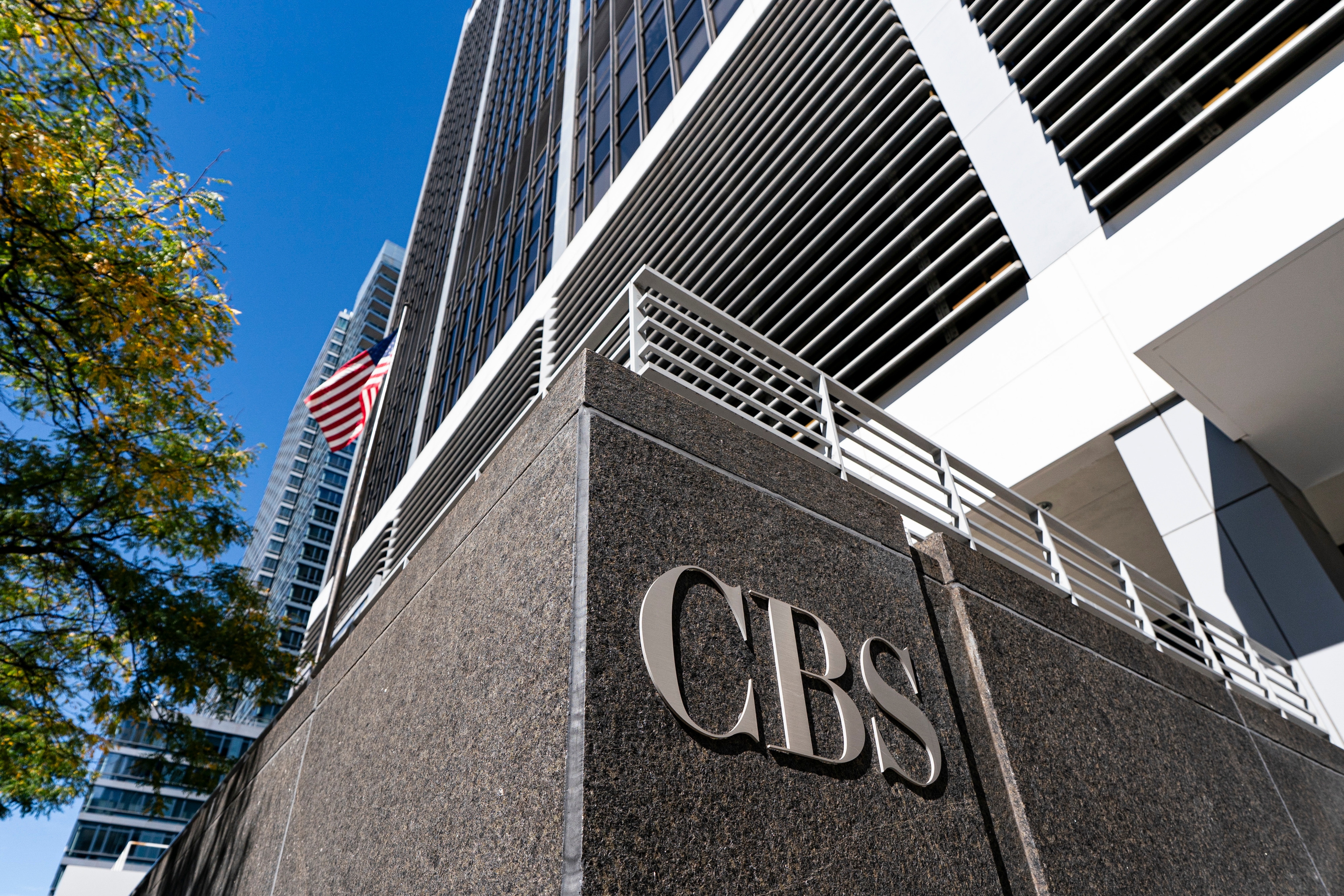CBS building exterior with American flag and skyscrapers