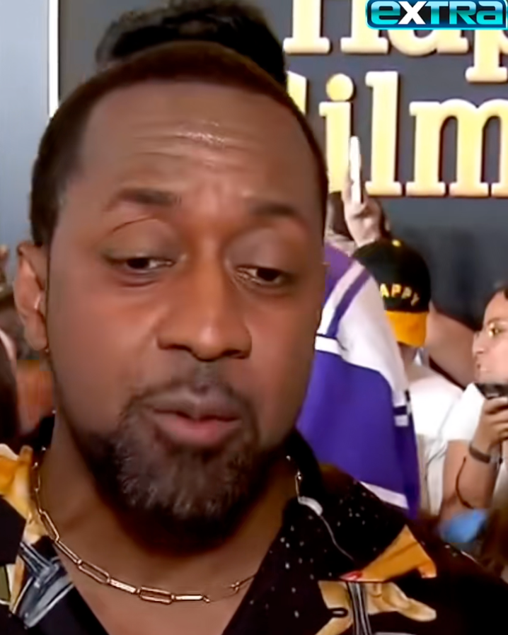 Jaleel White giving an interview at an event, wearing a patterned shirt