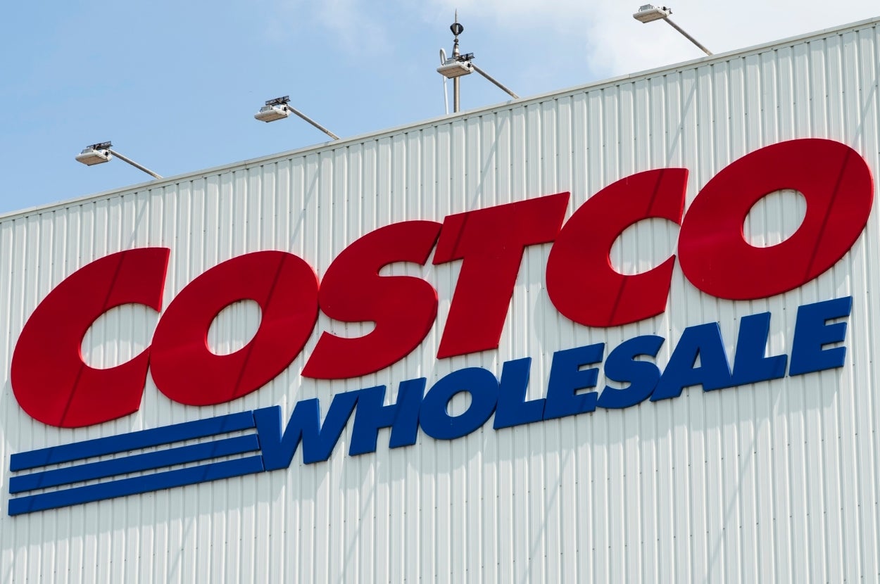 Costco store exterior with a large sign saying "Costco Wholesale" on the building's facade