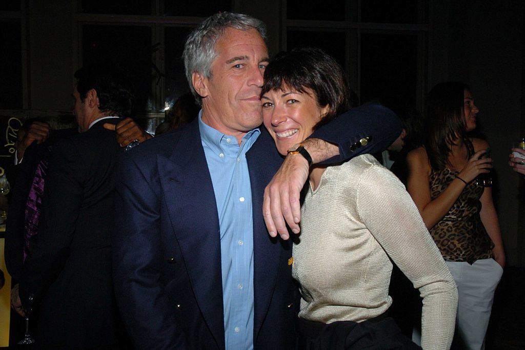 Jeffrey Epstein and Ghislaine Maxwell pose closely at an event, surrounded by other attendees