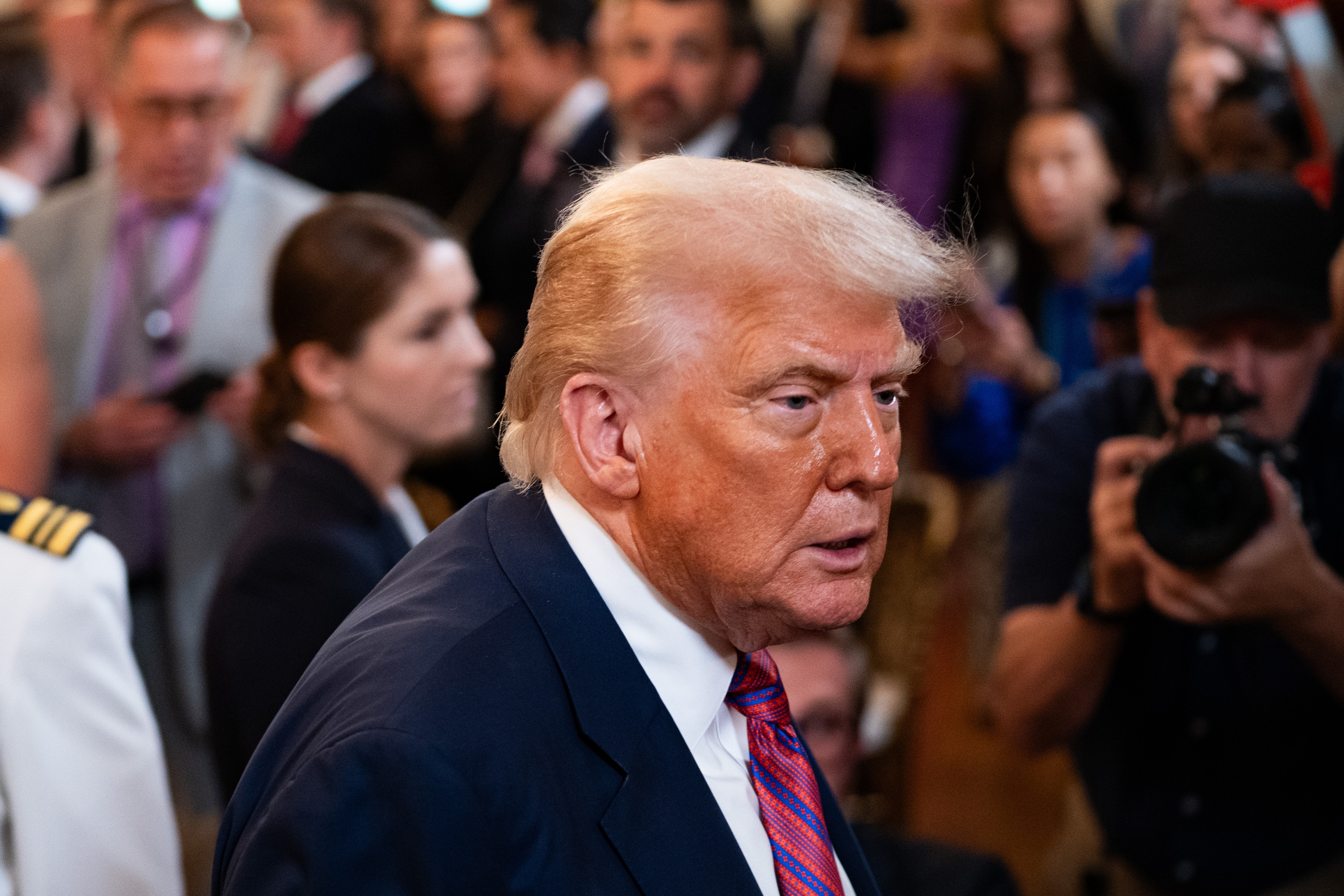 President Donald Trump exits after signing the GENIUS Act at the White House in Washington, DC, on July 18, 2025
