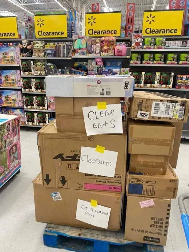 Stack of boxes connected  a store   pallet labeled "Clear Ants," apt  meant to accidental    "Clearance," surrounded by discounted toys