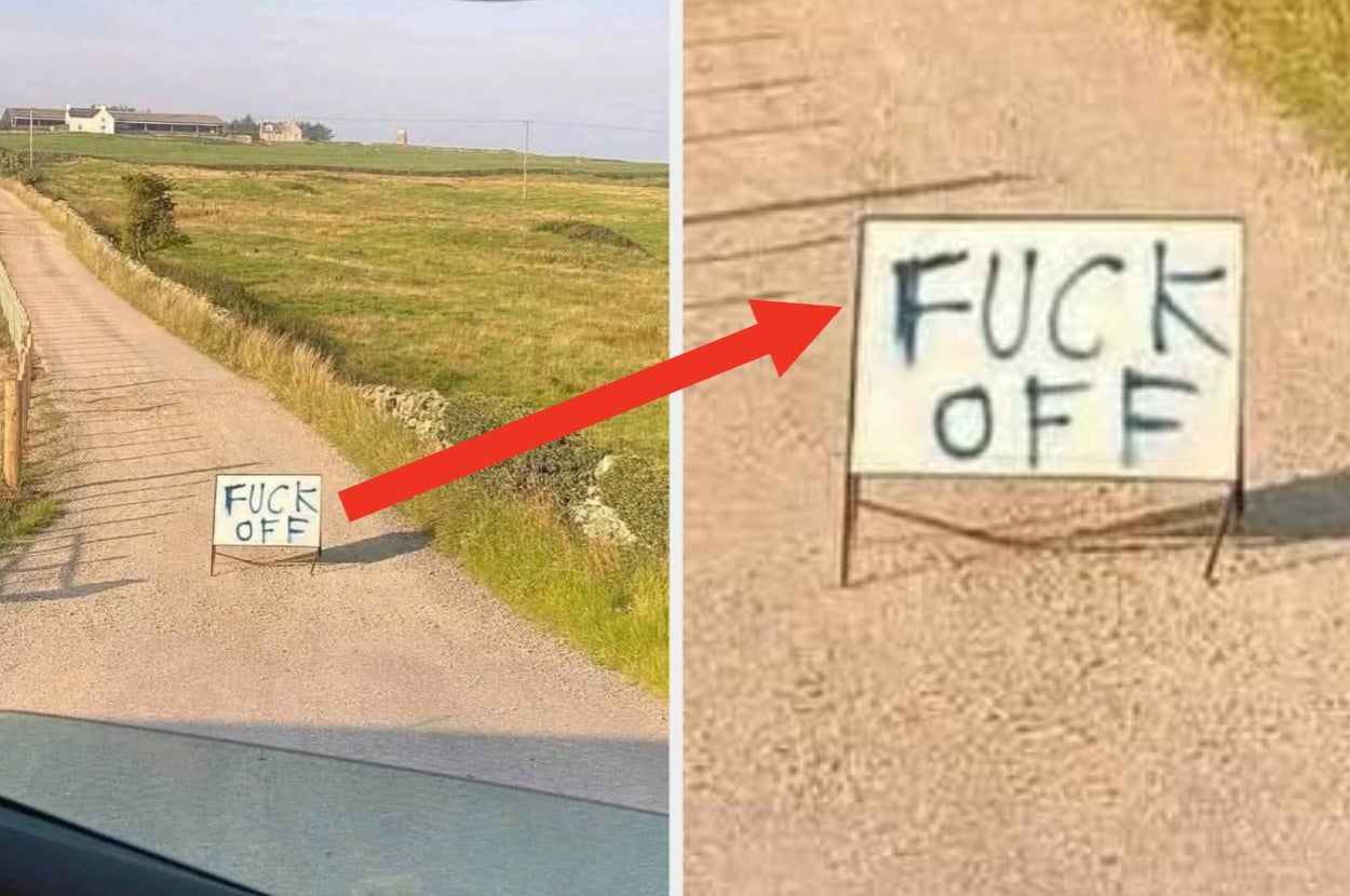 Rural gravel road with a large, hand-painted sign that says "FUCK OFF" placed in the middle of the path