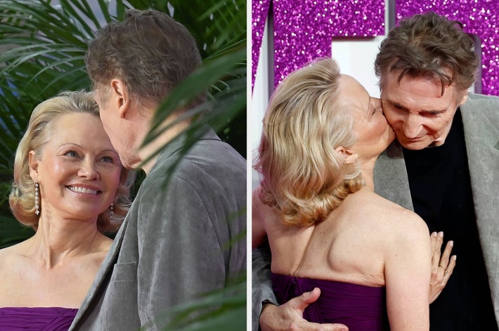 Two people embrace on a red carpet. The person on the left wears an elegant strapless gown and the person on the right wears a sleek blazer