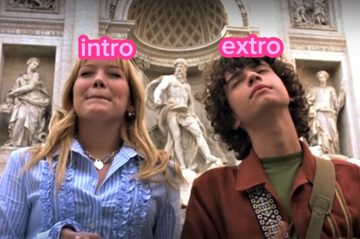Two people stand outdoors with text labels above them reading "intro" and "extro." A sculpture is in the background
