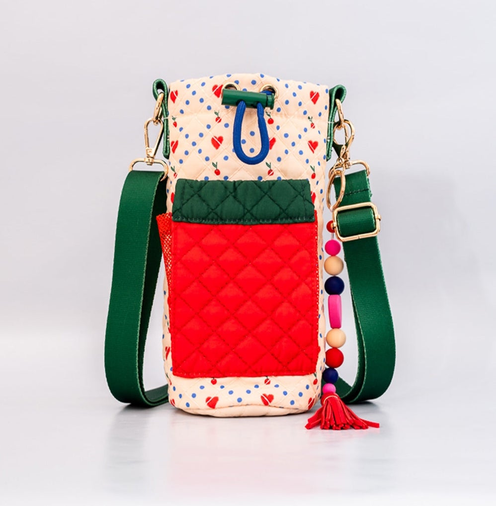 Quilted crossbody with adjustable toggle and crossbody strap, with heart print fabric and red and green fabric phone pocket