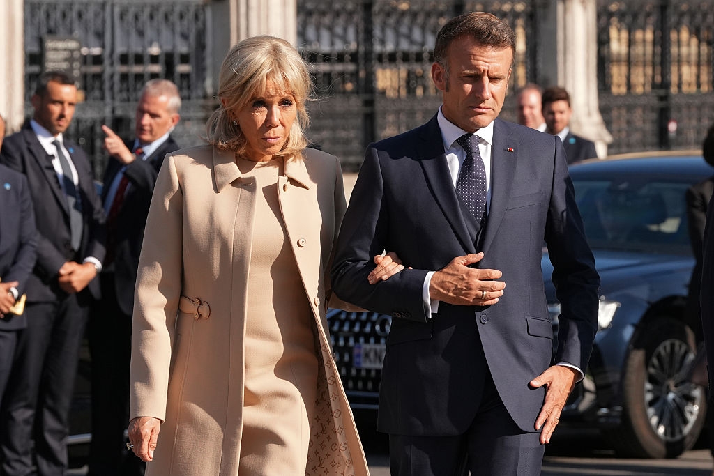 French President Emmanuel Macron and his wife Brigitte Macron arrive to attend a ceremony at the statue of war-time Prime Minister Winston Churchill in Parliament Square on July 8, 2025 in London, England