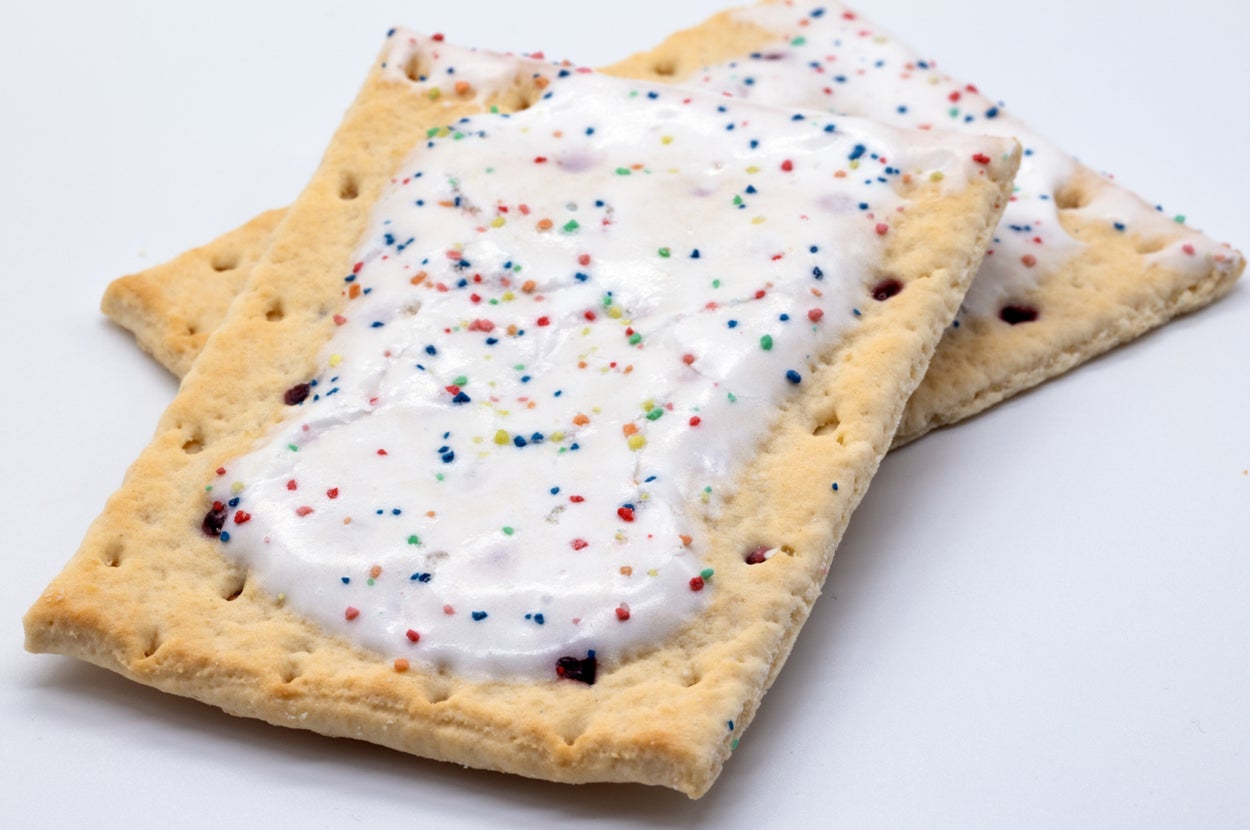 Two frosted blueberry Pop-Tarts with colorful sprinkles, stacked on a flat surface
