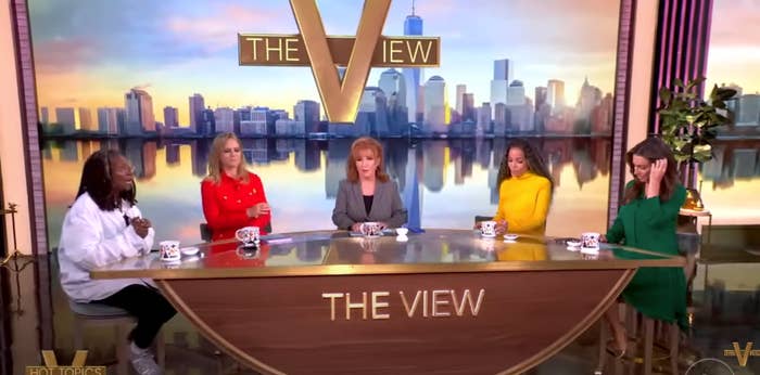 Five people sit at &quot;The View&quot; talk show table, each wearing distinct, stylish outfits, engaged in a discussion