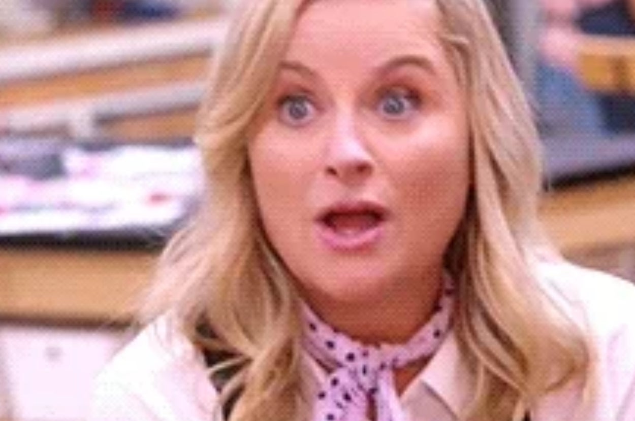 A surprised woman in casual clothes next to a packaged loaf of bread with a yellow arrow pointing at it
