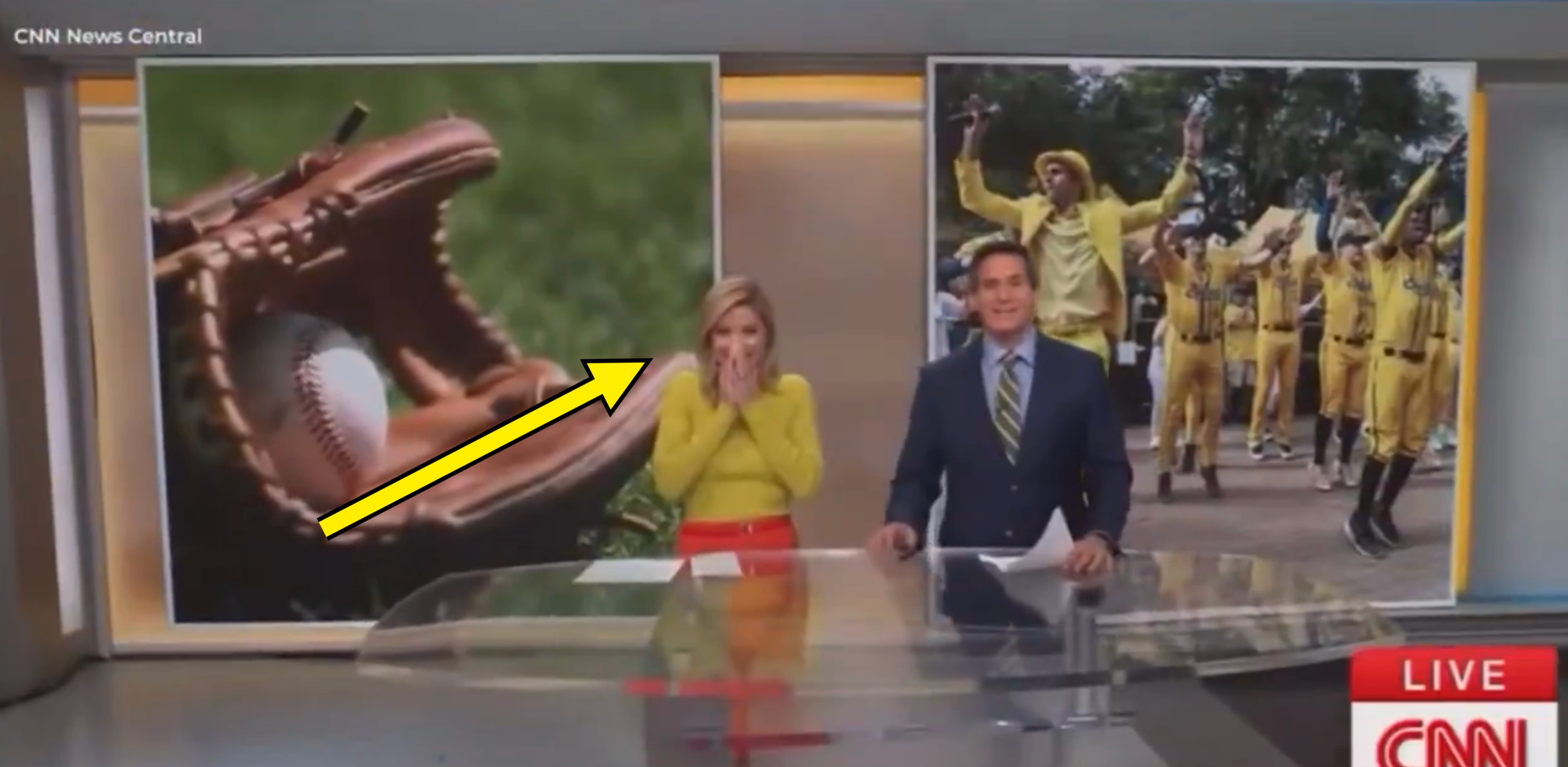 Two news anchors at a CNN desk, smiling. A baseball mitt image and a celebration photo are displayed on screens behind them