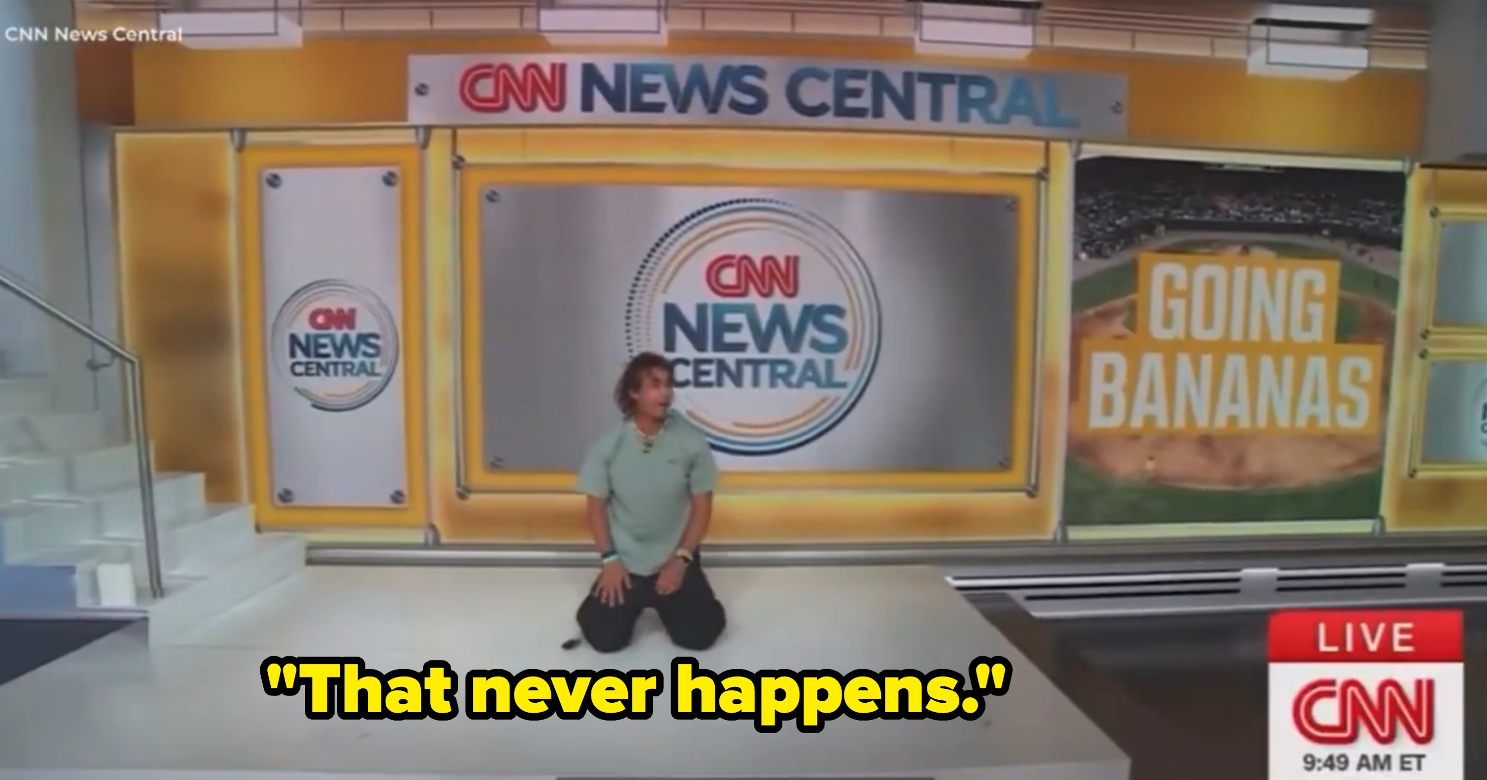 Person kneeling in a CNN News Central studio with sports theme on a screen displaying "Going Bananas."