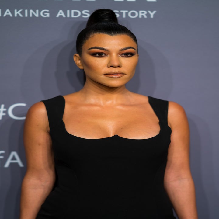 Kourtney Kardashian with a tight raised ponytail an an event