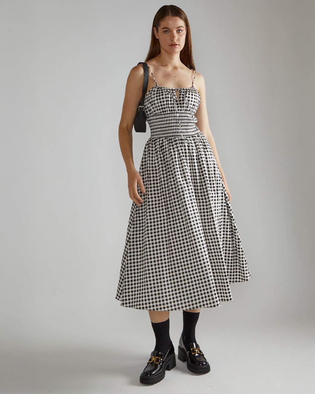 model in black and white gingham spaghetti strap midi