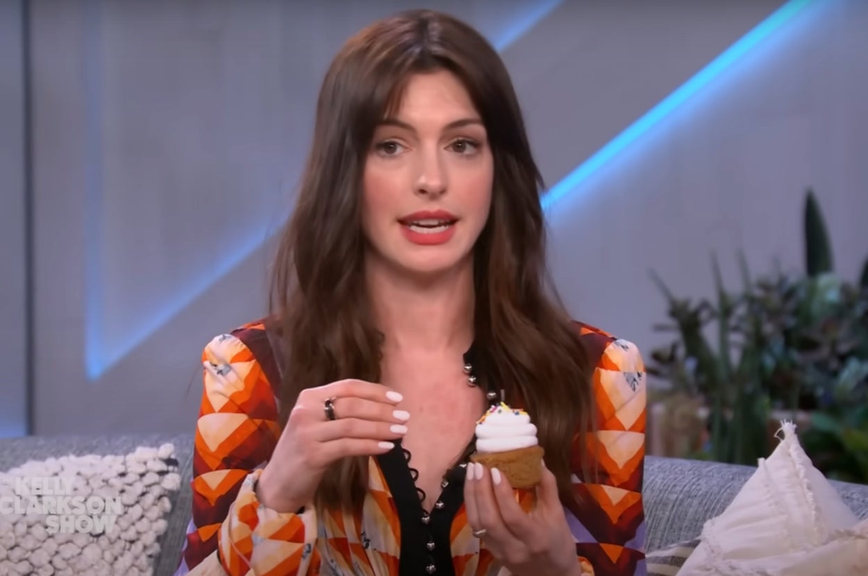 Anne Hathaway holding a cupcake