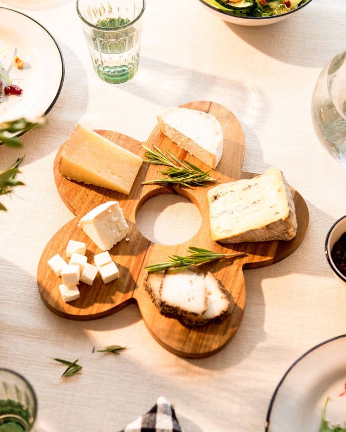 wooden flower-shaped cheese board with hole in middle