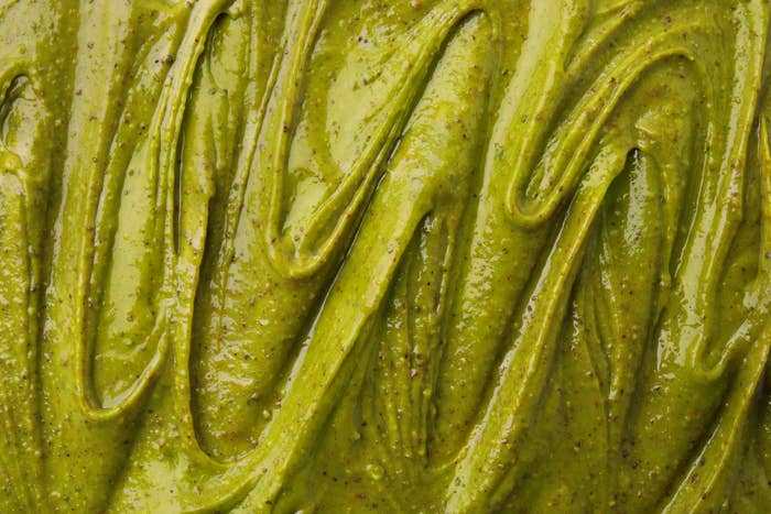 Smooth, creamy green sauce with a textured surface, ideal for pairing with various dishes