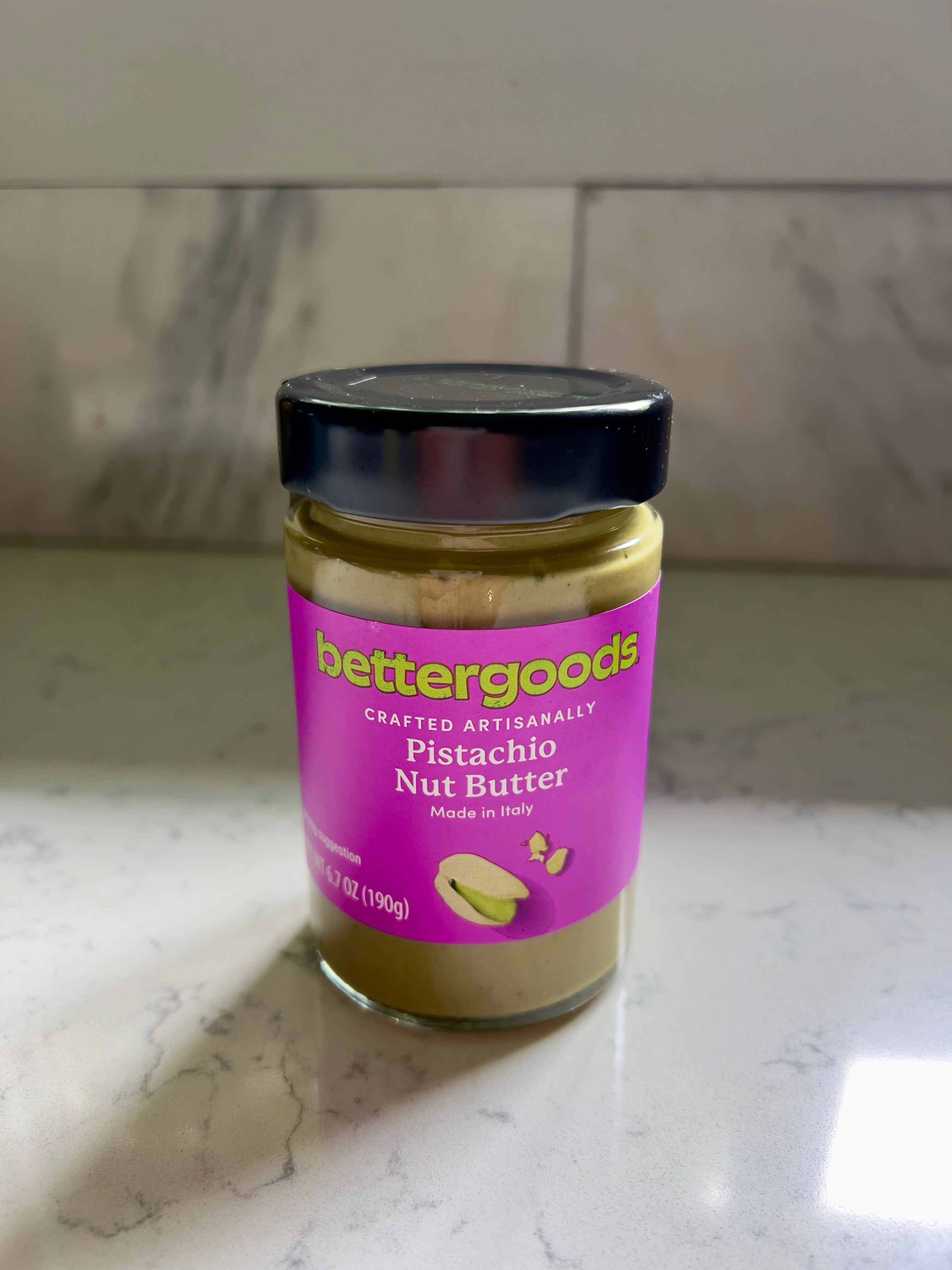 Jar of Bettergoods pistachio nut butter on a marble countertop