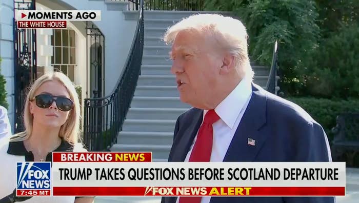 Donald Trump speaks to reporters outside the White House, wearing a suit and red tie, before departing for Scotland