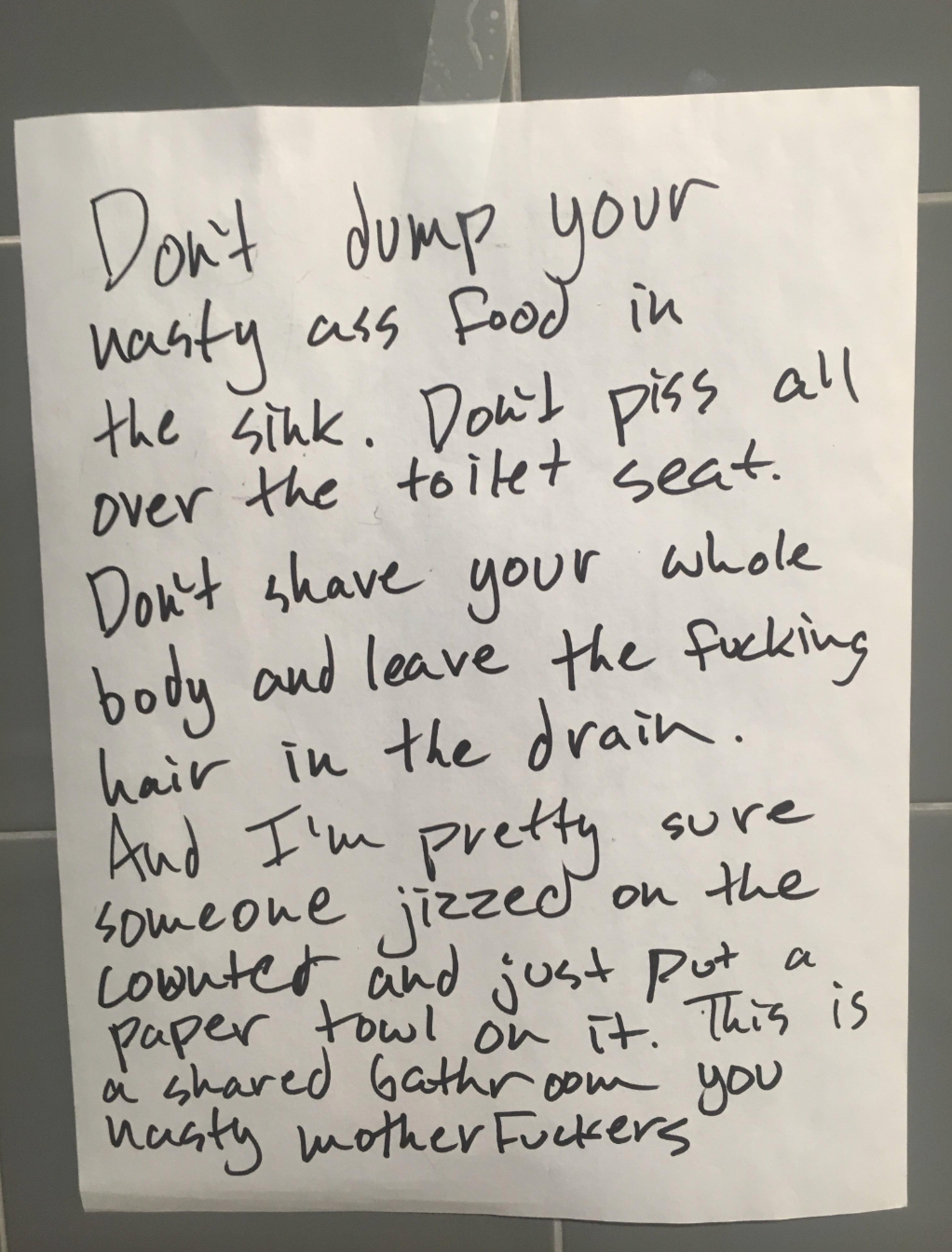 Note with complaints about bathroom cleanliness, including food disposal in sink, hygiene issues, and inappropriate cleanup methods