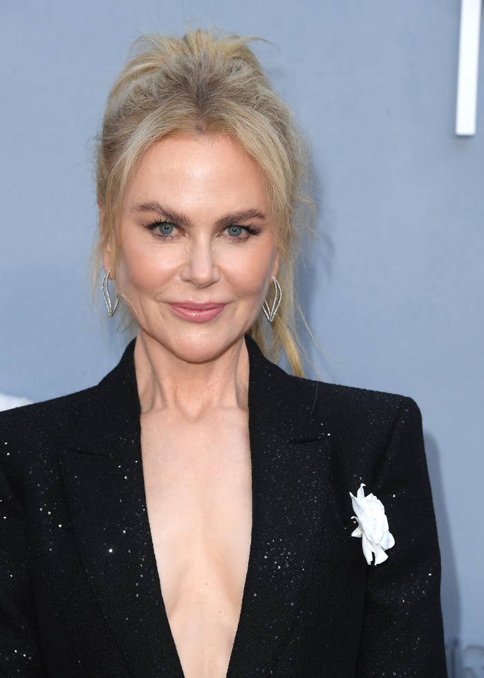 Nicole Kidman in elegant blazer with deep neckline and floral detail, attending a formal event