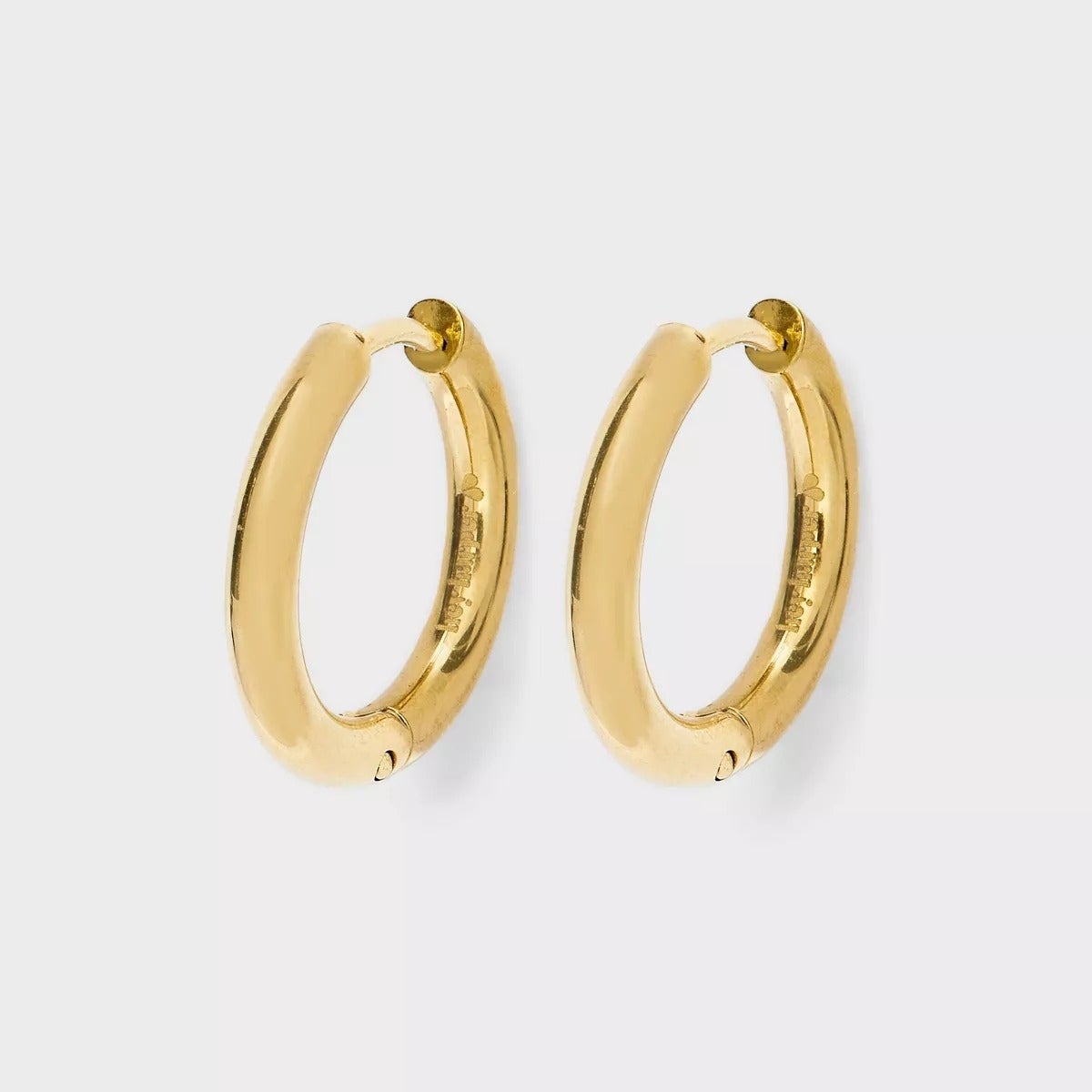 Gold hoop earrings with a smooth, polished decorativeness  displayed against a plain background. Ideal for versatile, mundane  wear