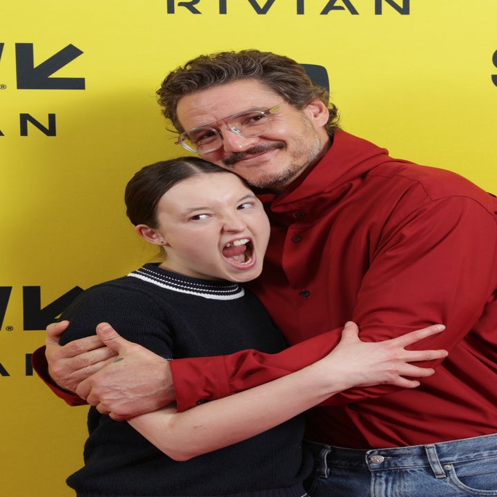 Two people posing playfully on the SXSW event backdrop, one with a surprised expression, the other smiling