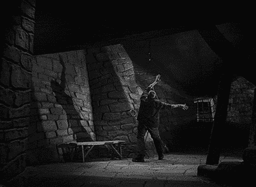 Ilustración en blanco y negro de una escena dramática en un calabozo de piedra, con una figura elevando los brazos hacia una luz tenue