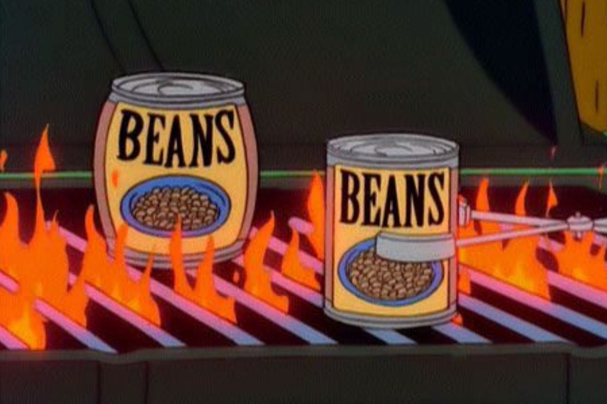 Two cans labeled "BEANS" sit on a flaming grill from "The Simpsons"