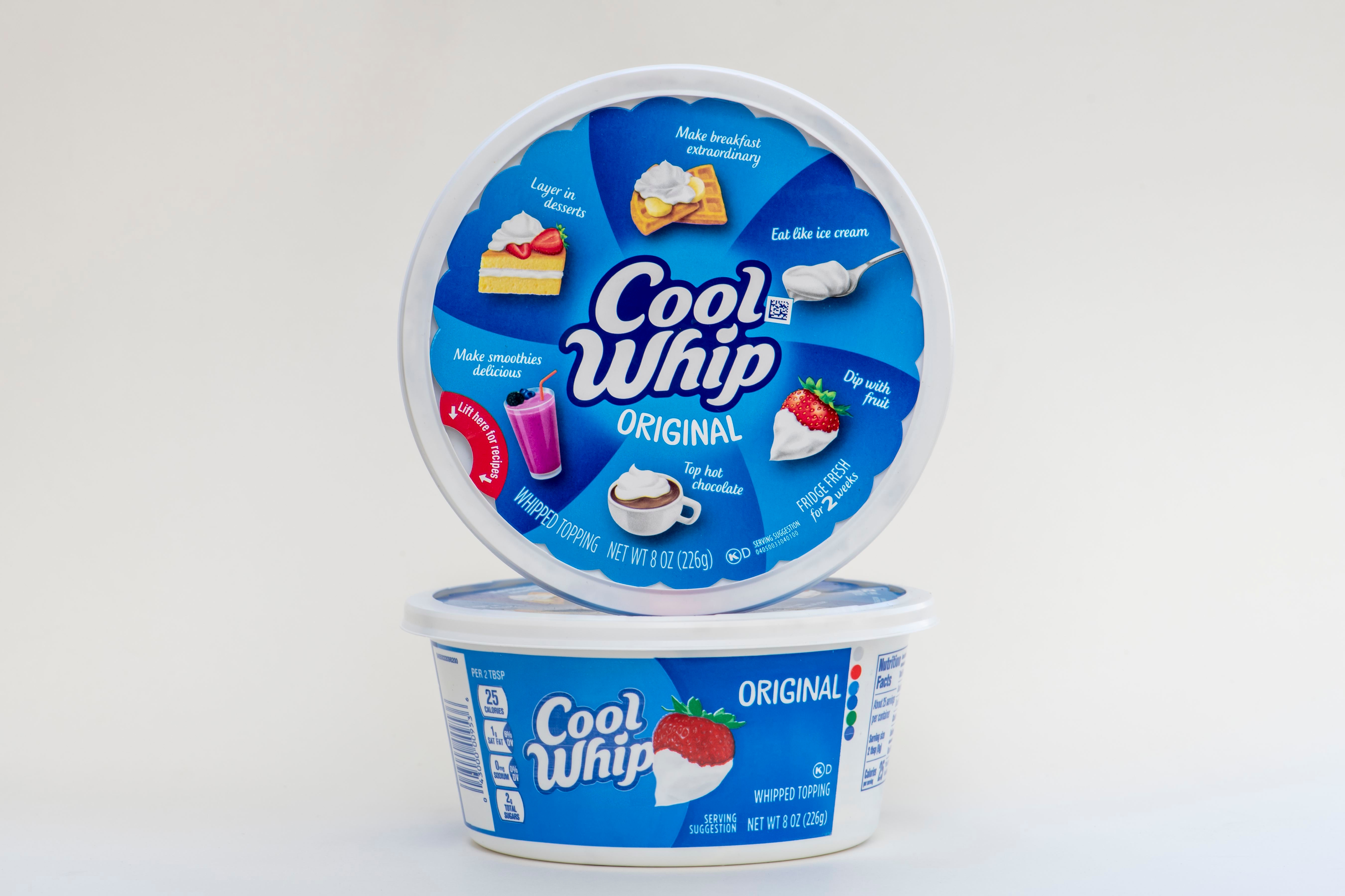 Cool Whip original whipped topping containers stacked, showcasing suggested uses like on pie, cake, and with berries