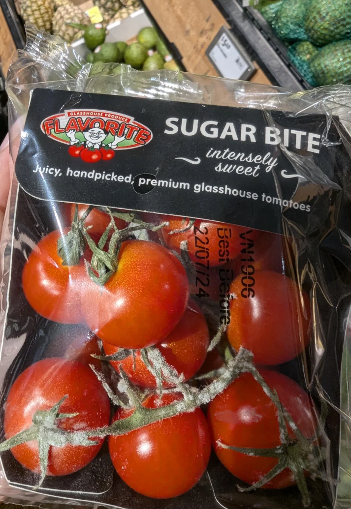 A Reddit post shows a photo of tomatoes labeled "Sugar Bite." User comments suggest mold on the produce is increasingly common