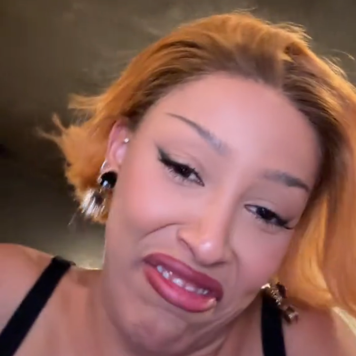 Woman with short hair making a playful facial expression while looking at the camera